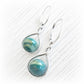 Pair of memorial earrings with hand blown glass marbles with ashes permanently encased in glass