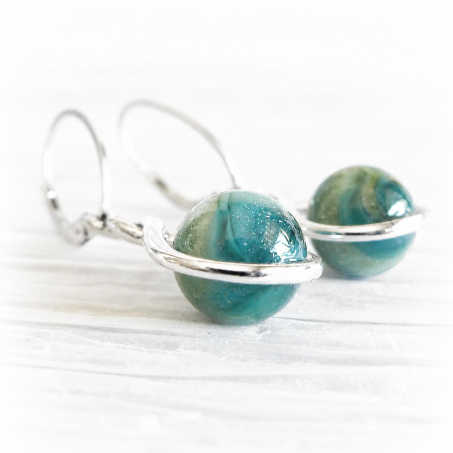 Ashes encased in aqua and turquoise hand blown glass marbles set in sterling silver memorial earrings 