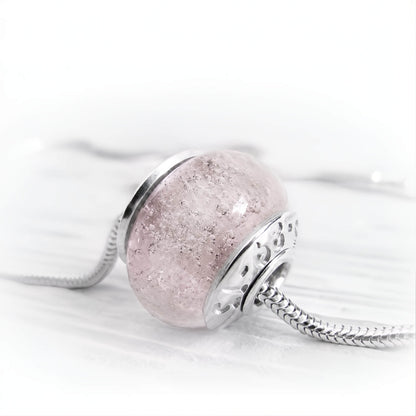 Light pink cremation bead set in sterling silver bead caps with  personalized inscription