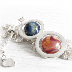 Handcrafted memorial glass marbles in a sterling silver double ring memorial pendant with a silver heart charm