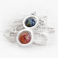 Artisan forged sterling silver memorial necklace featuring two hand blown glass marbles swirled with pet ashes