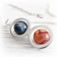 Handmade memorial necklace with two colorful glass marbles swirled with cremation ashes 