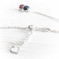 Sterling silver heart charm on a silver adjustable necklace with a memorial pendant in the background