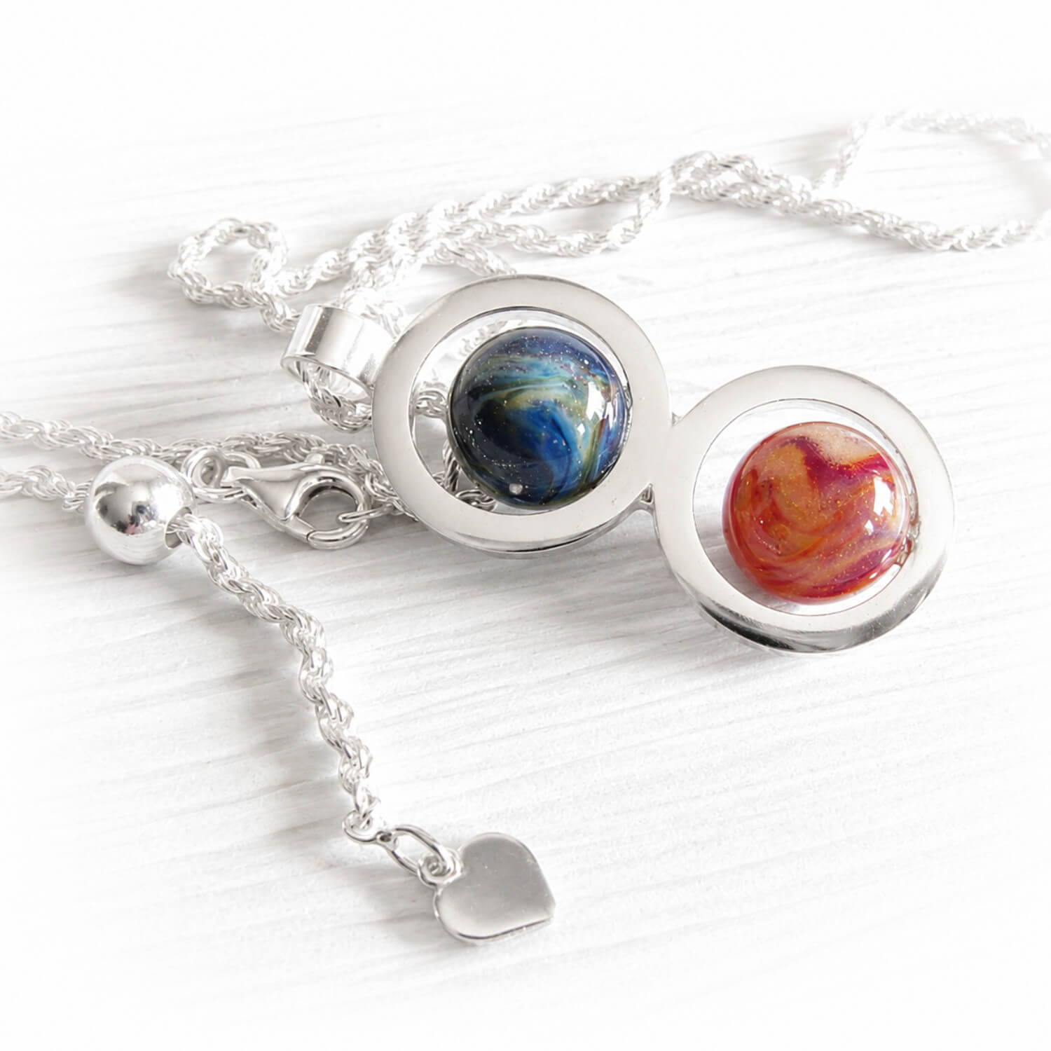 Sterling silver double ring pendant holding a pair of handmade glass marbled created using cremation ashes