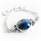 Swirls of blue glass mixed with cremation ashes set in a sterling silver memorial necklace