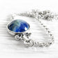 Handmade sterling silver memorial necklace with blue glass infused with cremation ashes