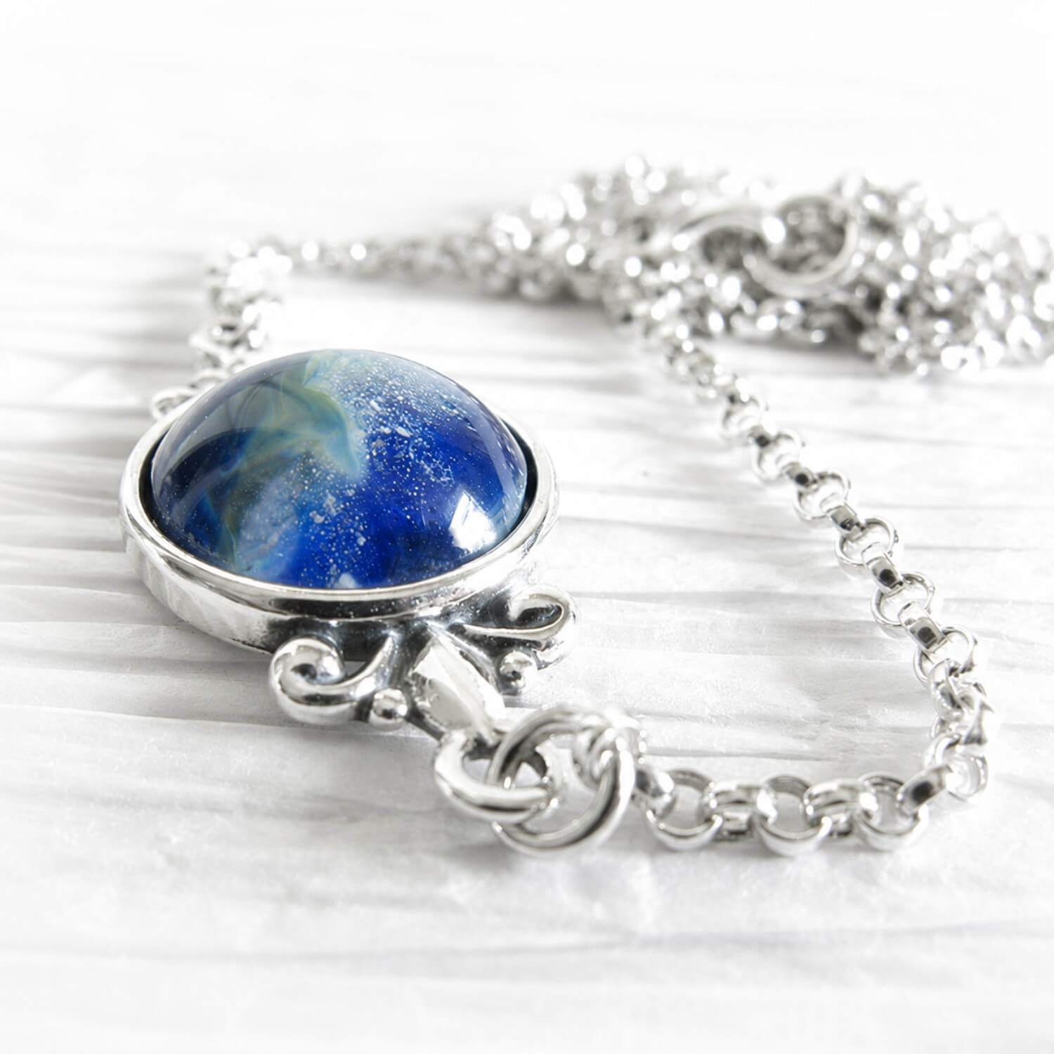 Handmade sterling silver memorial necklace with blue glass infused with cremation ashes