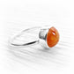 Orange hand blown glass encasing cremation ashes set into a polished sterling silver memorial ring
