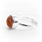 Polished sterling silver memorial ring featuring a hand blown glass gem with ashes permanently encased in glass 