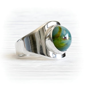 Hand blown cremation glass set in a sterling silver artisan forged memorial ring