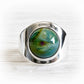 Hand blown glass gem stone made with cremation ashes and an artisan forged sterling silver setting