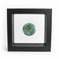 Hand blown aqua and green glass cremation memory stone in a black suspension frame