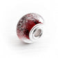 Dark red ash infused glass bead with sterling silver bead caps on a white background