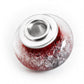 Dark red glass bead infused with cremation ashes set with sterling silver bead caps