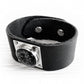 Black leather cuff bracelet with sterling silver accents featuring handcrafted black glass with cremation ashes
