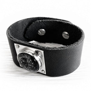 Black leather cuff bracelet with sterling silver accents featuring handcrafted black glass with cremation ashes