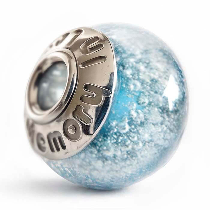 Blue glass memorial charm bead with engraving on a white background 