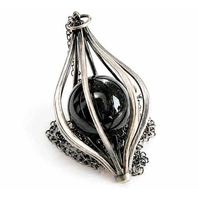 Silver pendant with a black cremation ash marble sphere on a white background