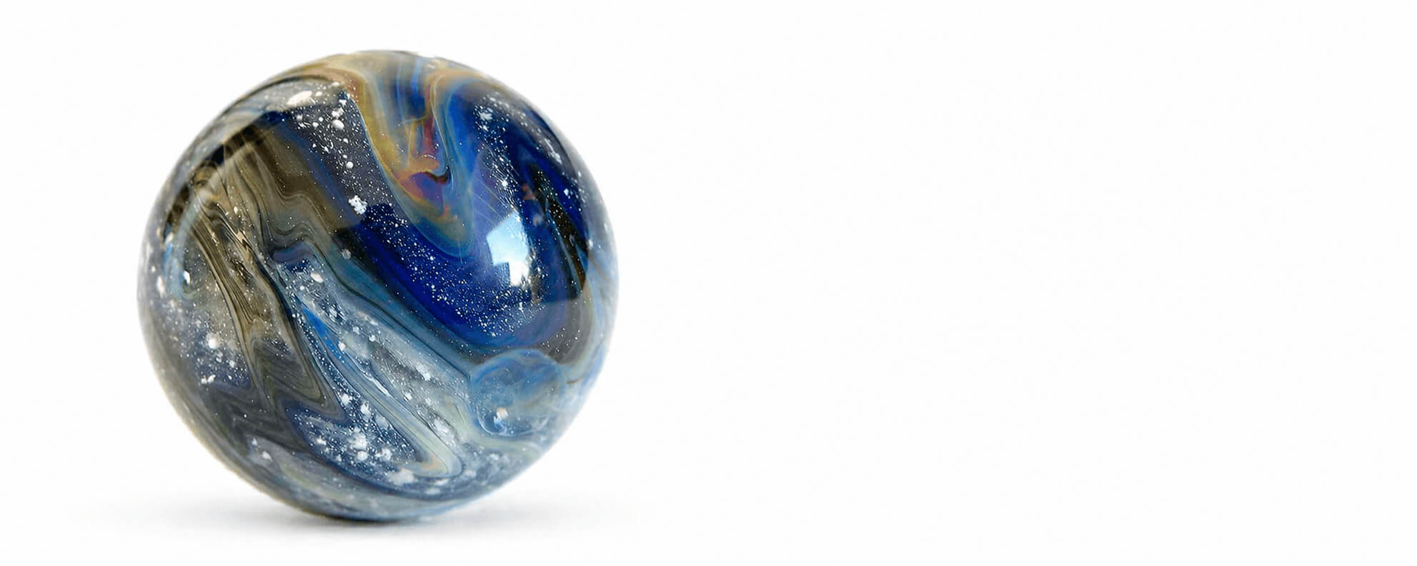 Blue and silver marbled glass cremations ash sphere marble on a white background
