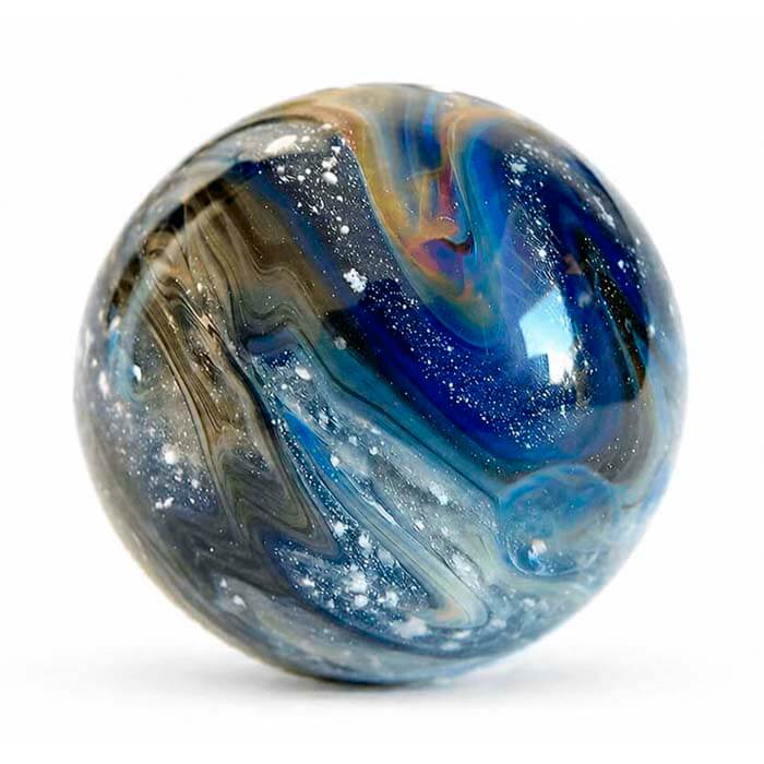 Cremation Ashes Glass marble with blue and brown swirls on a white background