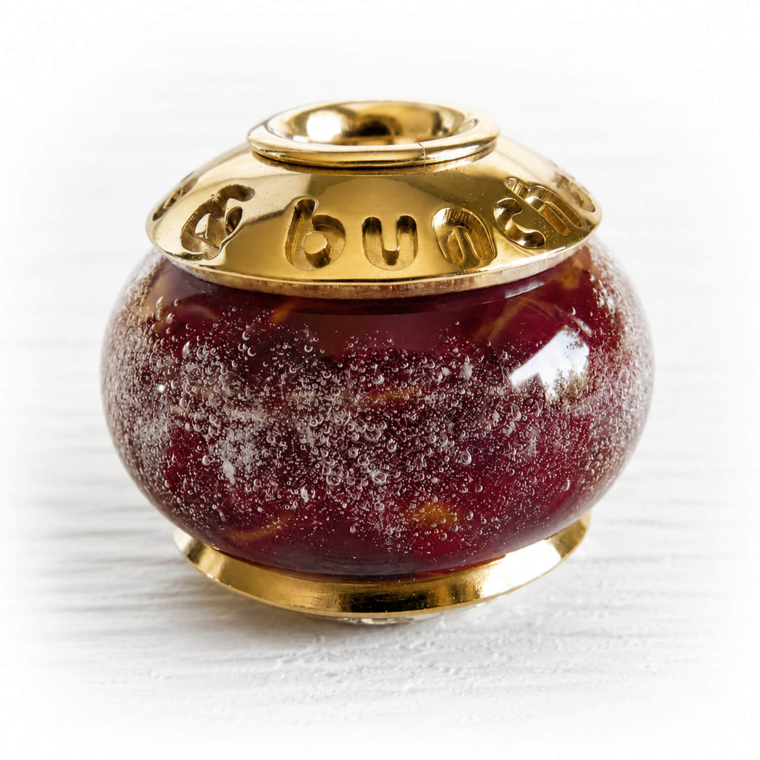 Cremation ashes encased over deep red hand blown glass set with custom engraved solid 14k gold bead caps