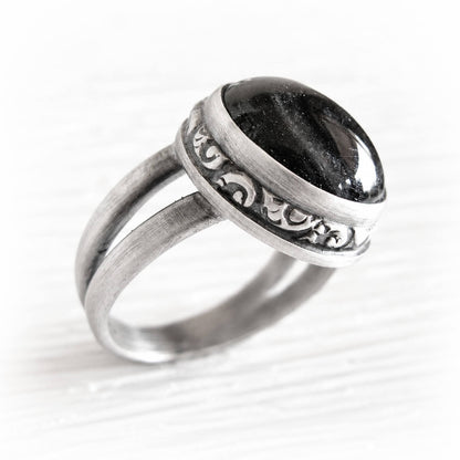 Sterling silver pet memorial ring with ashes encased in a black glass dome