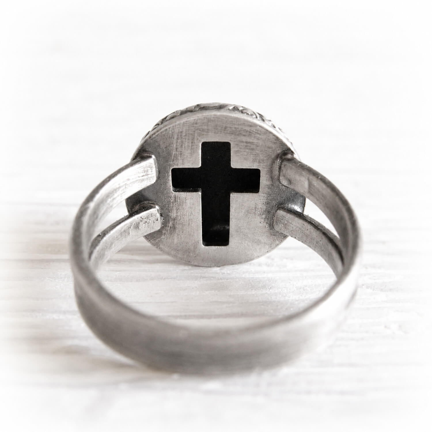 Sterling silver ring with a cross cutout on the back of a memorial ring