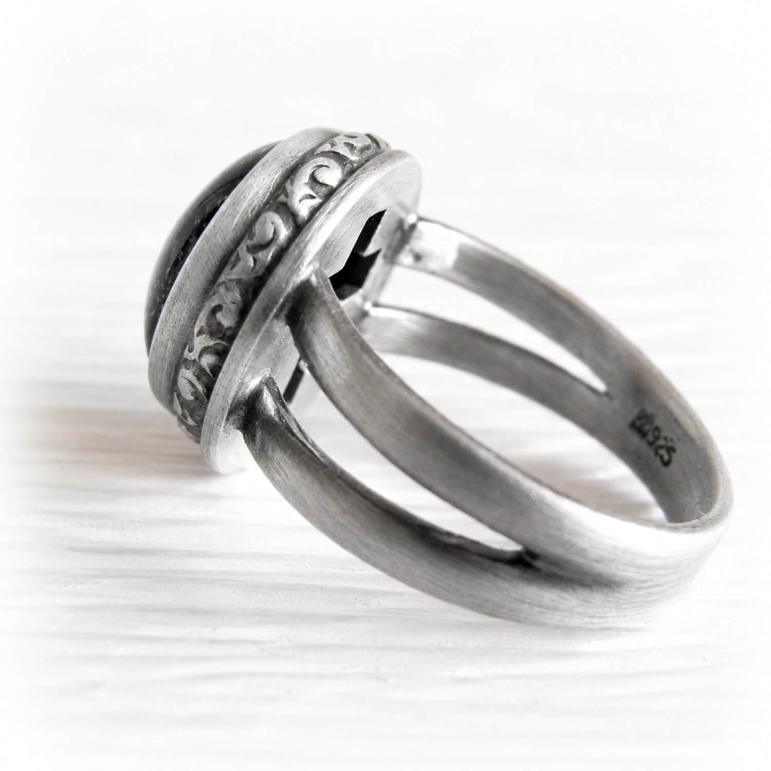 Antique finish on a sterling silver cremation ring with a cross cutout on the back