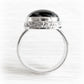 Sterling silver memorial ring with ashes permanently encased in black glass