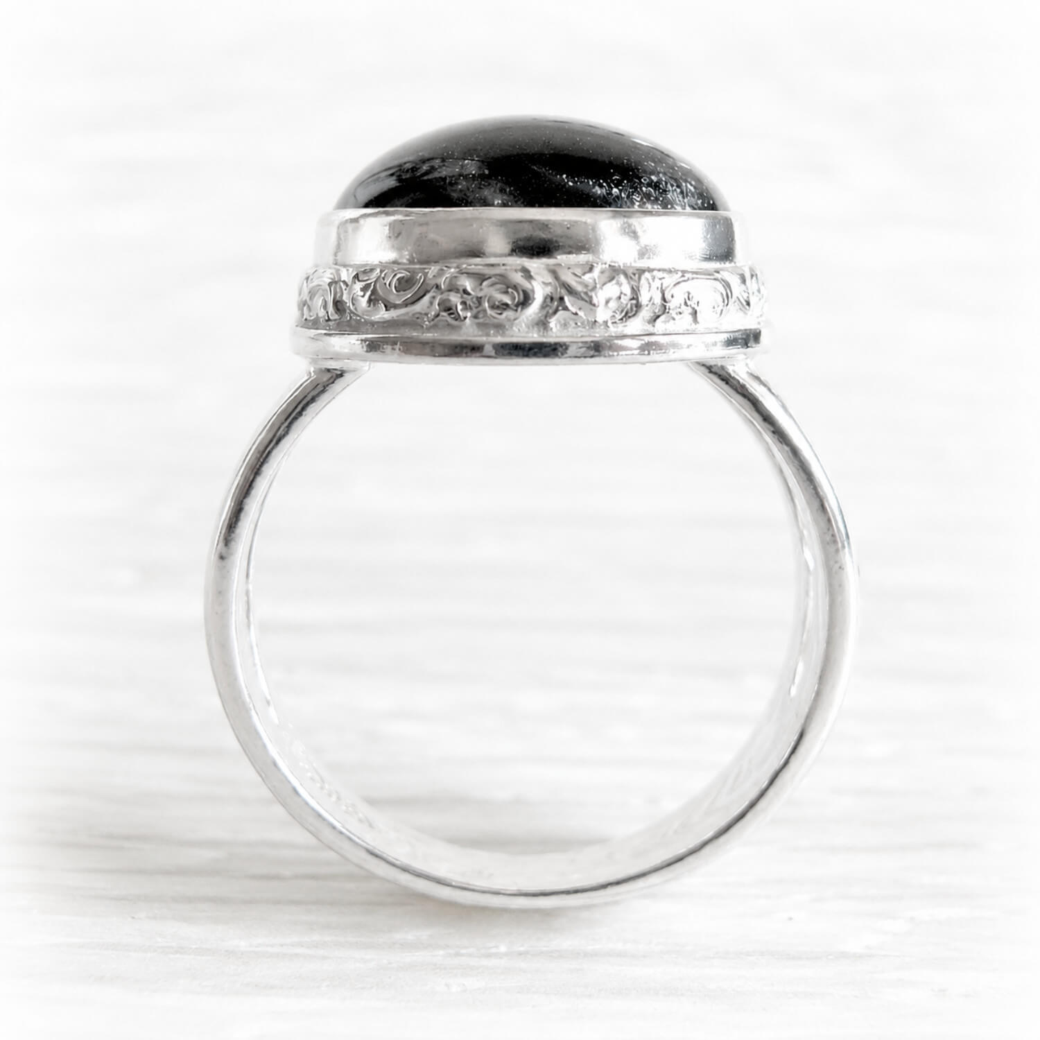 Sterling silver memorial ring with ashes permanently encased in black glass