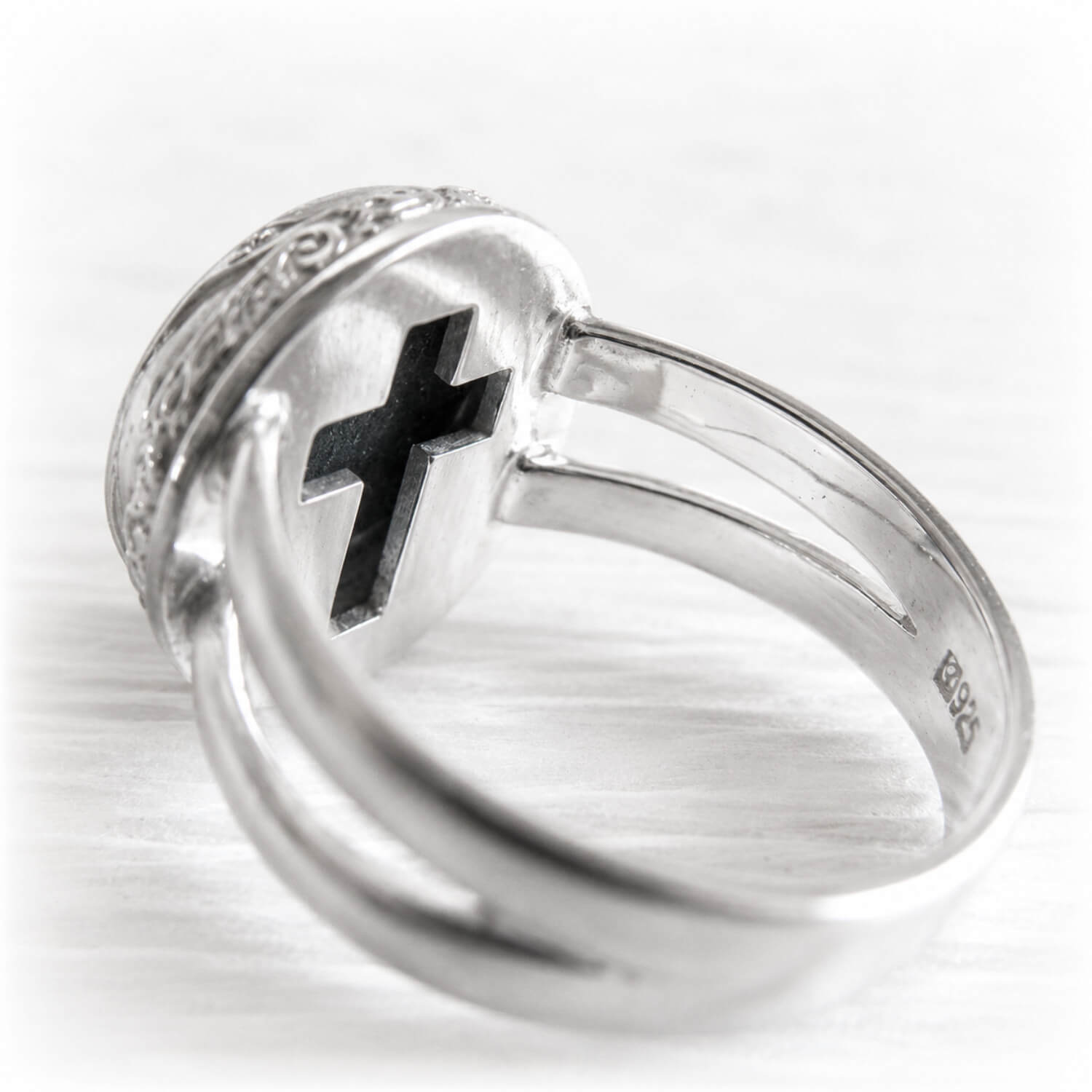 Cross cutout on the back of a sterling silver cremation ring containing the ashes of a loved one