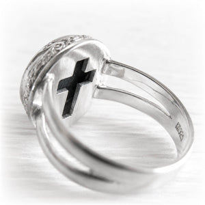 Cross cutout on the back of a sterling silver cremation ring containing the ashes of a loved one