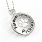 Sterling silver necklace with paw print pendant and 'Forever Loved Pickles' engraving on a white background