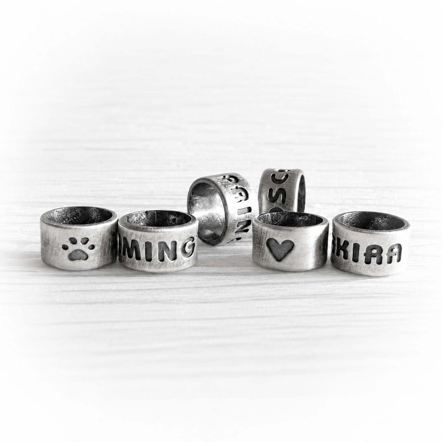 Set of handmade sterling silver slider beads with personalized engraving and an antique finish