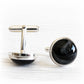 Memorial cufflinks with cremation ashes sealed within the glass