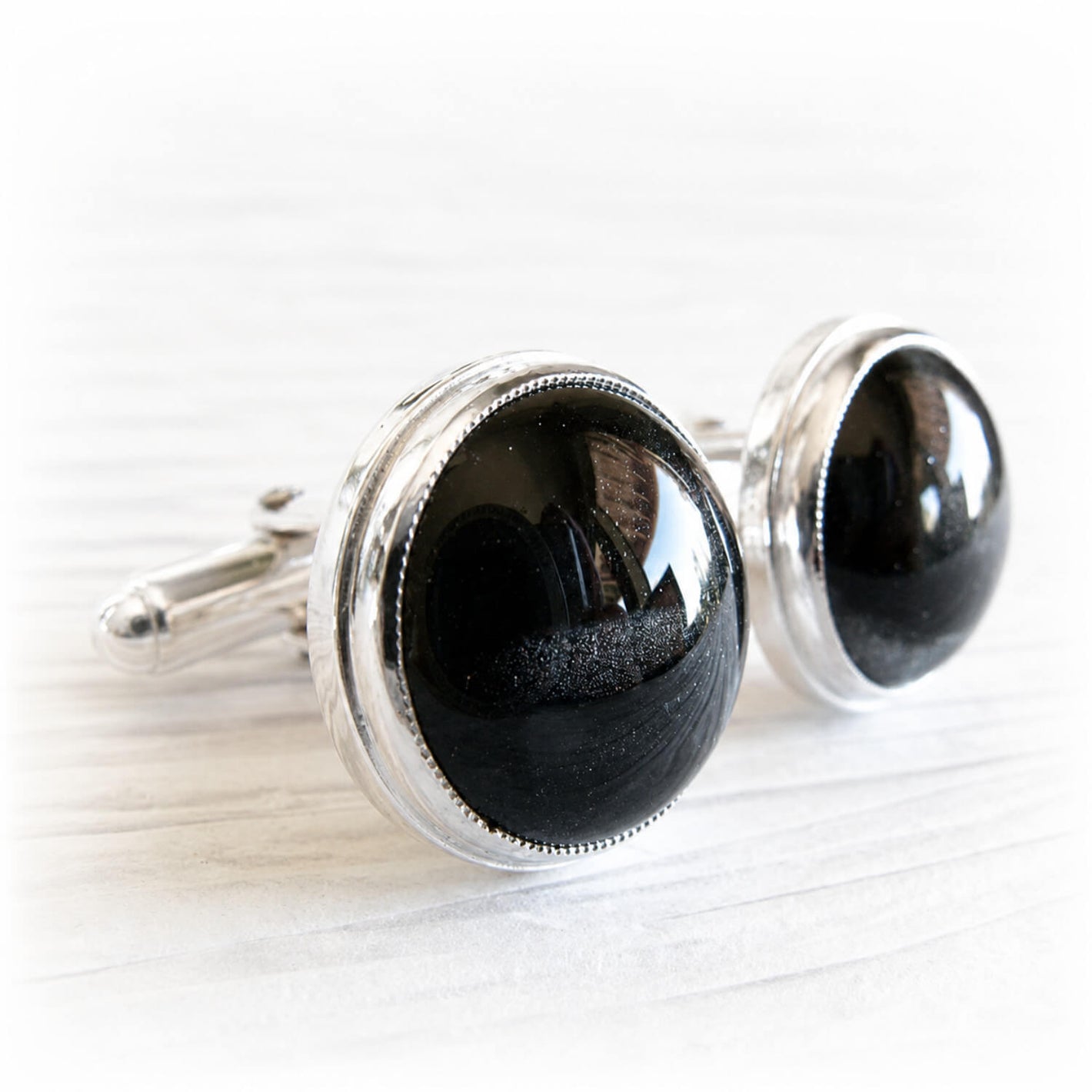 Pair of sterling silver cremation cufflinks with black hand blown glass with ashes inside the glass
