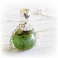 Green and brown Spring Sparkle hand blown glass focal marble set on a polished sterling silver necklace