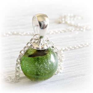 Green and brown Spring Sparkle hand blown glass focal marble set on a polished sterling silver necklace