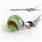 Memorial necklace with a green and brown marbled glass pendant set on sterling silver with an antique finish
