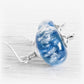 Swirling blue cremation bead drop earrings accented with silver end caps and french hooks