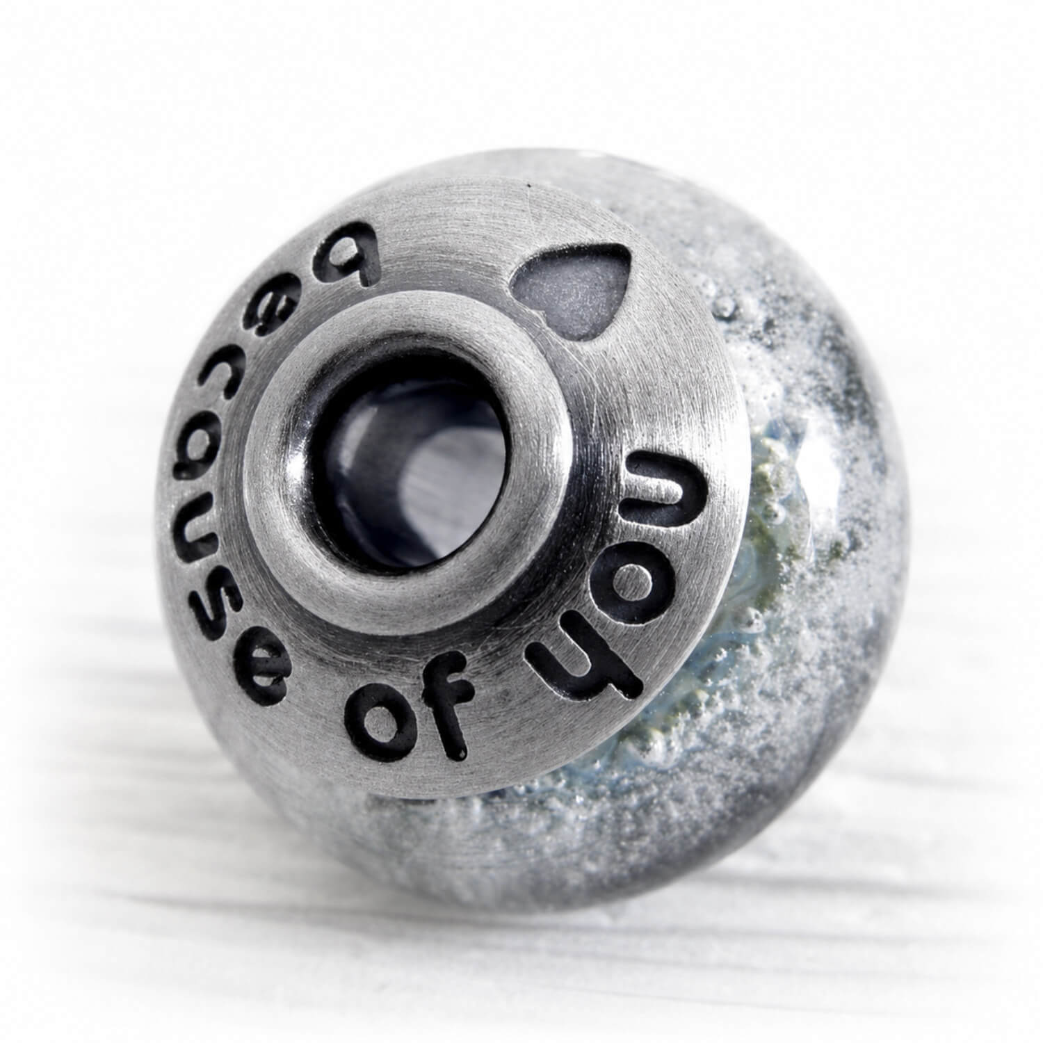Antique finished sterling silver bead caps on a hand blown glass memorial bead