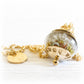 Cremation ash necklace charm with polished gold decorative caps and an amber and yellow hand blown glass bead