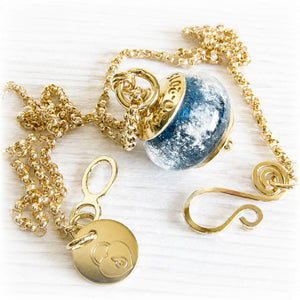 14k gold memorial jewelry featuring a blue charm bead pendant handcrafted with cremation ashes