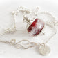 Red Artisan made glass memorial bead pendant on a sterling silver necklace