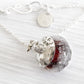Artisan crafted cremation necklace with custom engraving on a white background