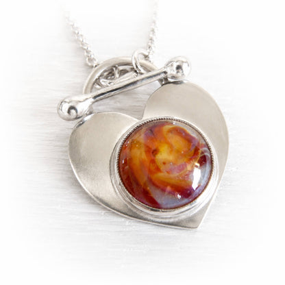 Sterling silver remembrance pendant with an swirled amber artisan-crafted cremation glass cabochon