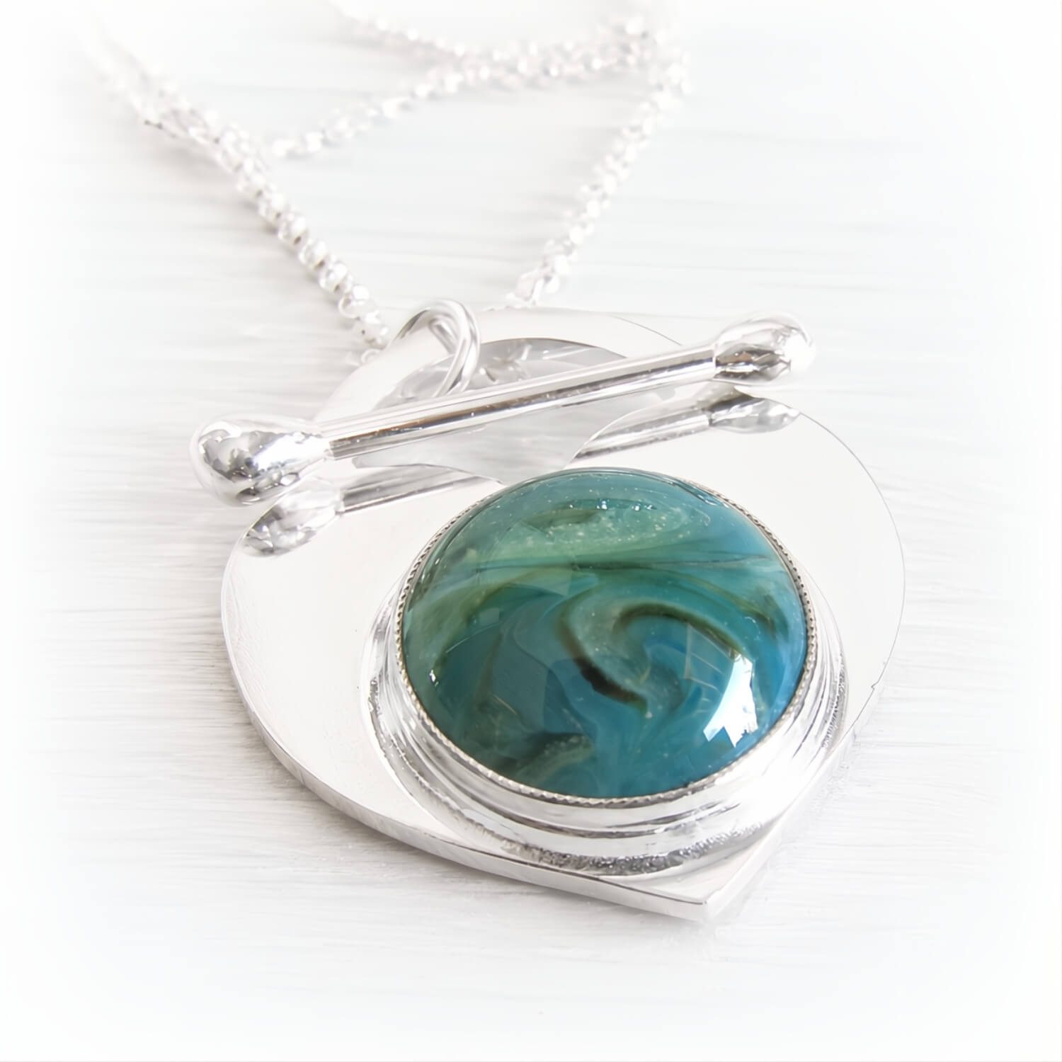 Solid sterling silver lariat cremation necklace with a handcrafted glass cabochon centerpiece containing cremation ashes