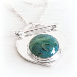 Solid sterling silver lariat cremation necklace with a handcrafted glass cabochon centerpiece containing cremation ashes