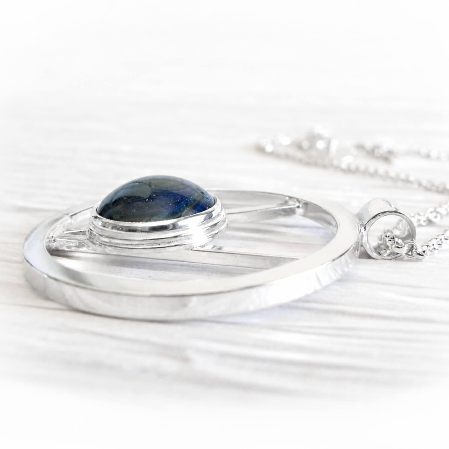 Sterling silver necklace pendant with blue handcrafted glass incorporating pet ashes