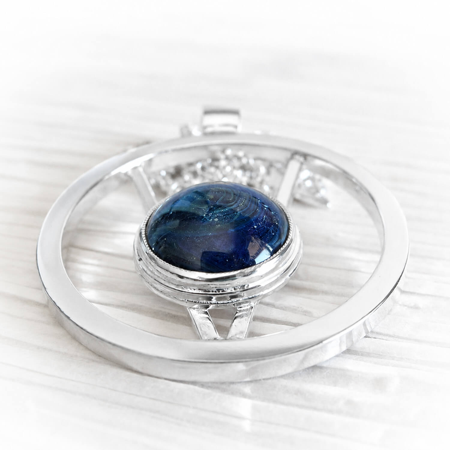 Sterling silver pendant with a blue glass gemstone handcrafted with cremation ashes